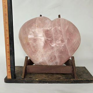19.8 lb Rose quartz heart shape on wooden stand with ruler for size; stand not included